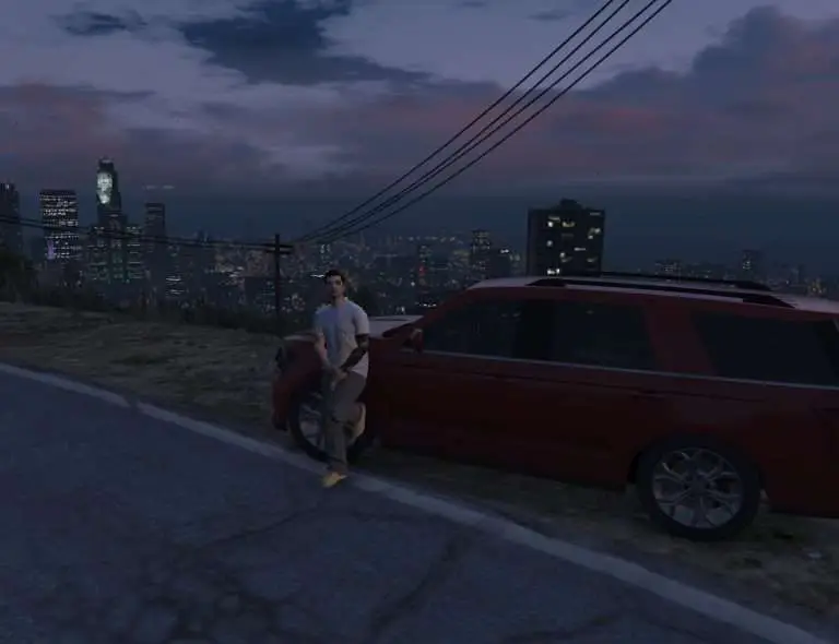 Driver standing with his car at night